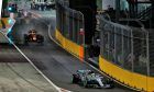 Mercedes' Lewis Hamilton and Red Bull's Daniel Ricciardo exit pit lane during the Singapore Grand Prix