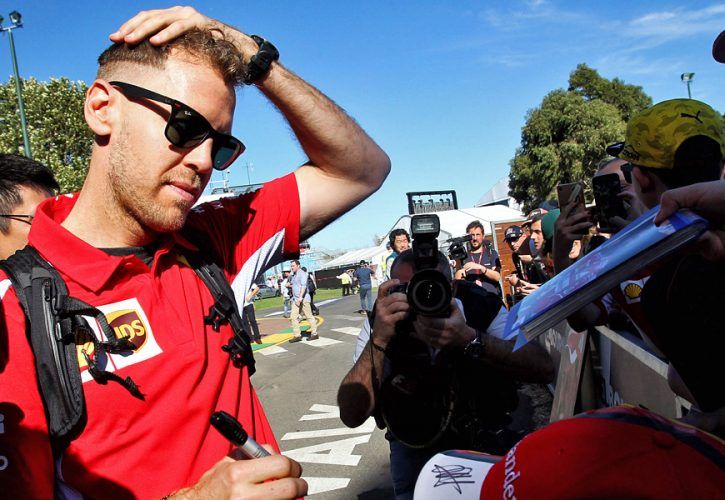 Sebastian Vettel (GER) Ferrari signs autographs for the fans.
