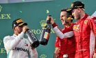 (L to R): Lewis Hamilton (GBR) Mercedes AMG F1 celebrates his second position with race winner Sebastian Vettel (GER) Ferrari.