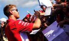 Sebastian Vettel (GER) Ferrari signs autographs for the fans.