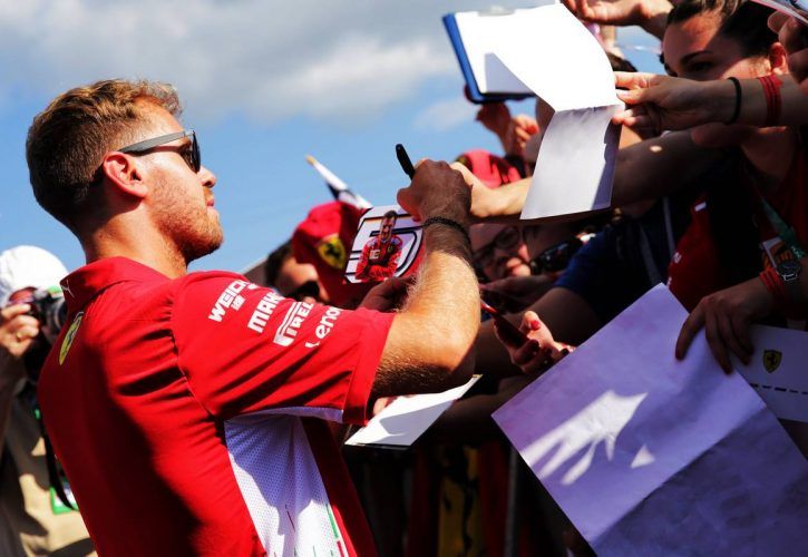 Sebastian Vettel (GER) Ferrari signs autographs for the fans.