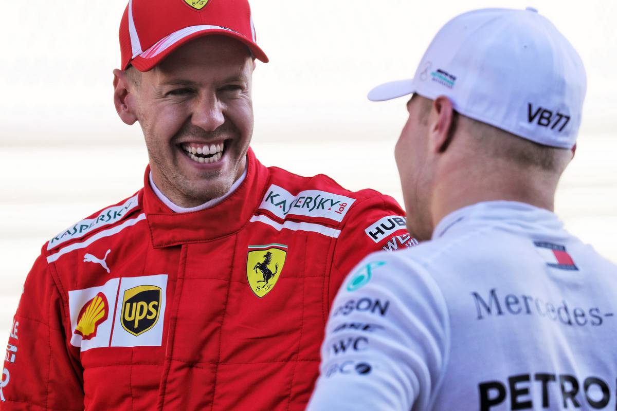 Sebastian Vettel (GER) Ferrari with pole sitter Valtteri Bottas (FIN) Mercedes AMG F1 in qualifying parc ferme.