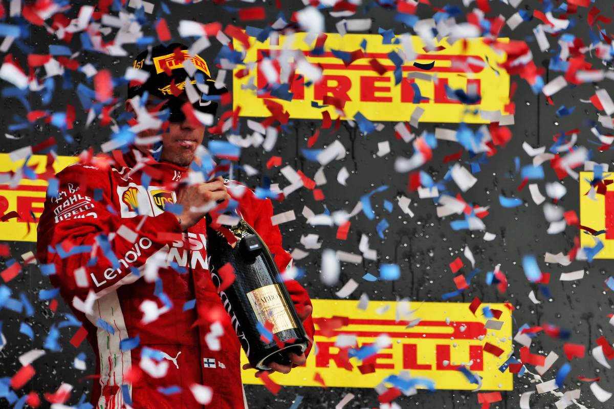 Race winner Kimi Raikkonen (FIN) Ferrari celebrates on the podium.