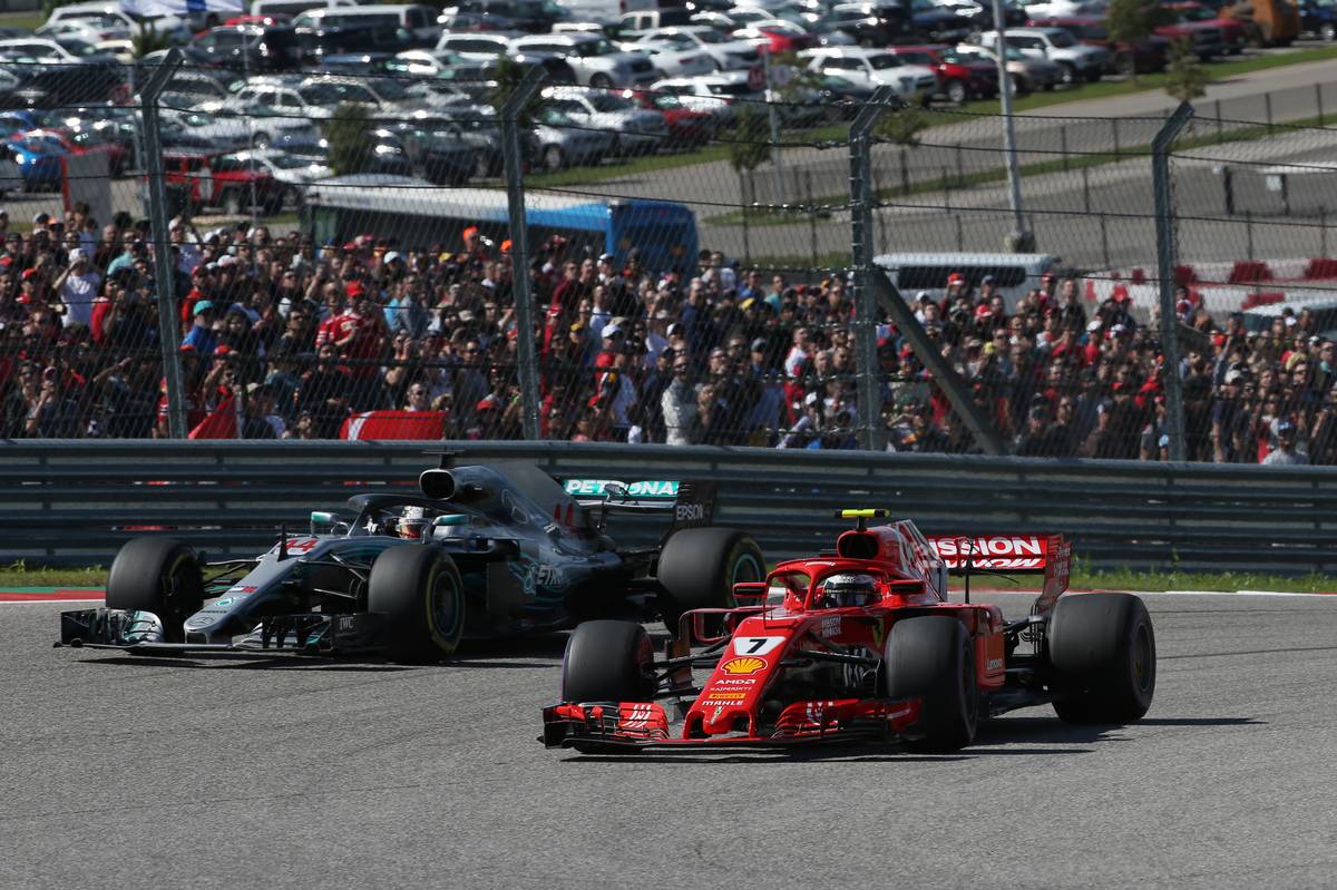 Kimi Raikkonen (FIN) Ferrari SF71H leads Lewis Hamilton