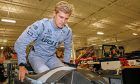 Marcus Ericsson slides into his car during his visit to the Schmidt Peterson Motorsports shop for his initial seat fit