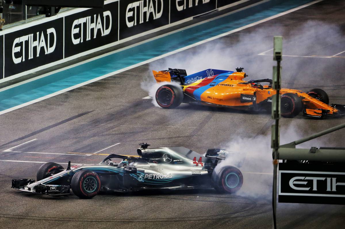 Abu Dhabi Grand Prix winner Lewis Hamilton (GBR) Mercedes AMG F1 W09 and Fernando Alonso (ESP) McLaren MCL33 perform doughnuts at the end of the race.