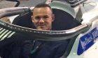 Wayne Rooney tries out the seat of José María López's Geox Dragon Penske car.