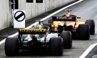 Fernando Alonso (ESP) McLaren MCL33 leads Nico Hulkenberg (GER) Renault Sport F1 Team RS18 out of the pits.