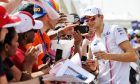 Esteban Ocon (FRA) Racing Point Force India F1 Team with fans.
