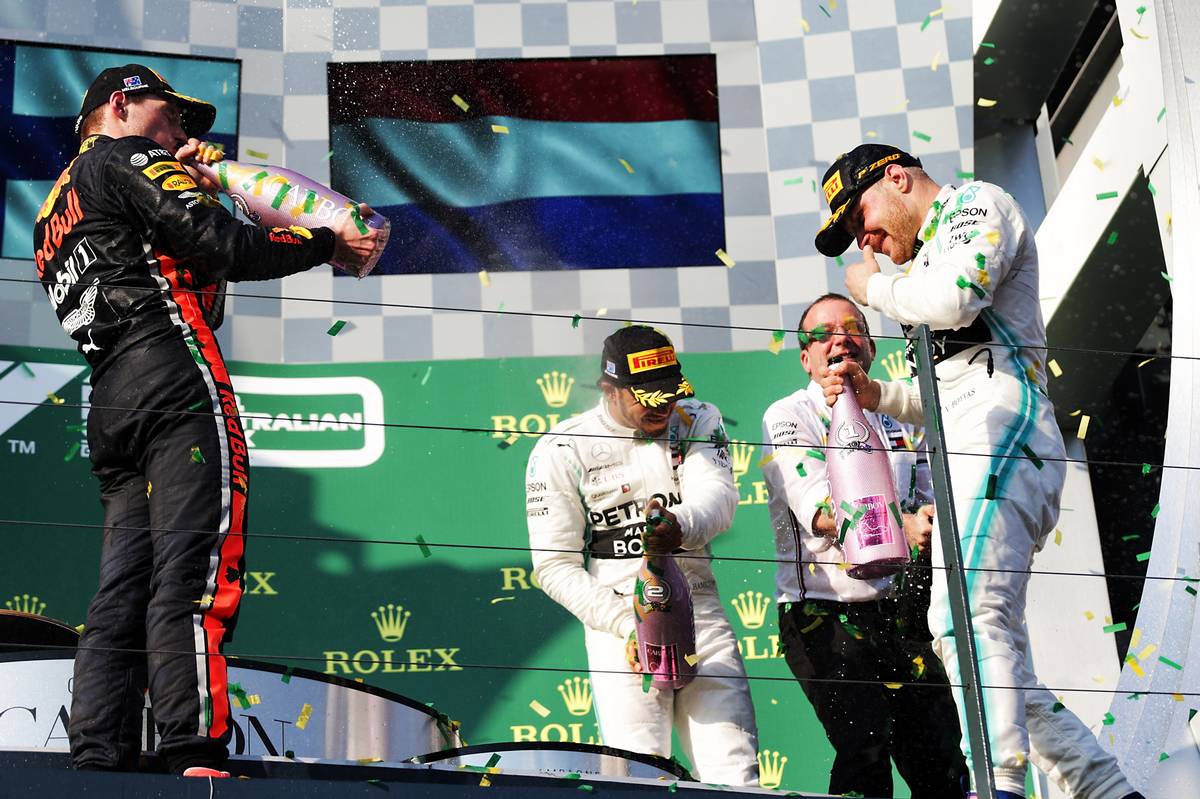 Max Verstappen (NLD) Red Bull Racing celebrates on the podium with Lewis Hamilton (GBR) Mercedes AMG F1 and race winner Valtteri Bottas (FIN) Mercedes AMG F1.