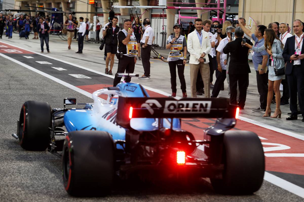 George Russell (GBR) Williams Racing FW42 passes David Beckham (GBR) Former Football Player.