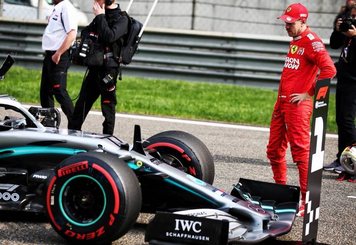 Sebastian Vettel (GER) Ferrari SF90 looks at the Mercedes AMG F1 W10 of pole sitter Valtteri Bottas (FIN)