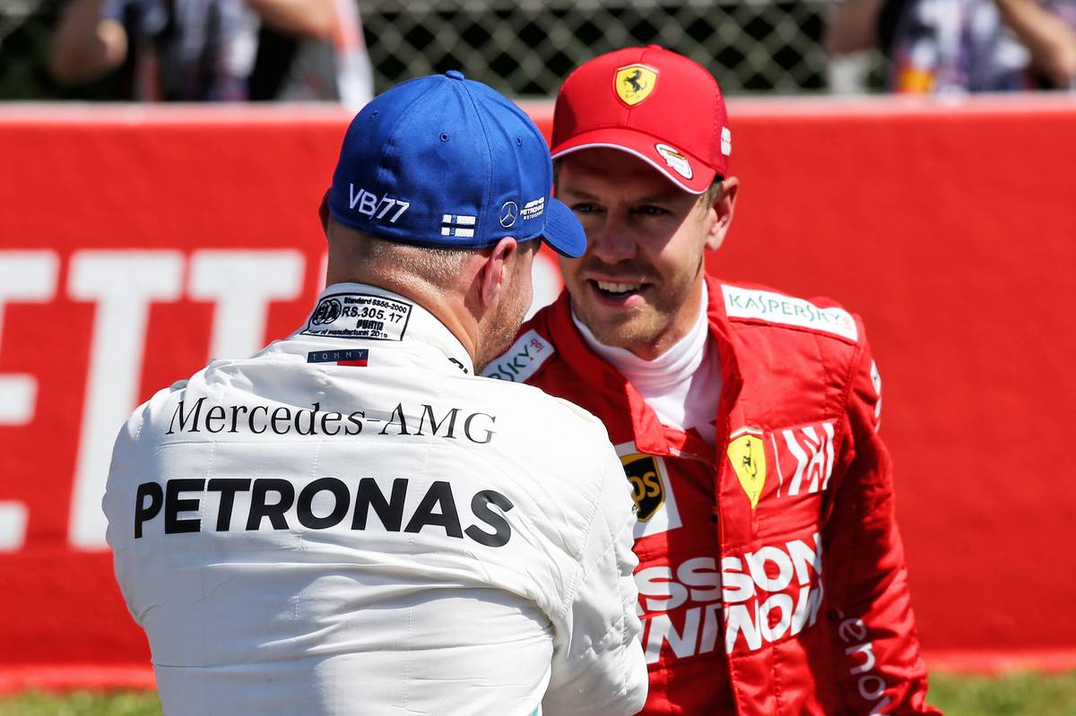 Valtteri Bottas (FIN) Mercedes AMG F1 celebrates his pole position in qualifying parc ferme with third placed Sebastian Vettel (GER) Ferrari.