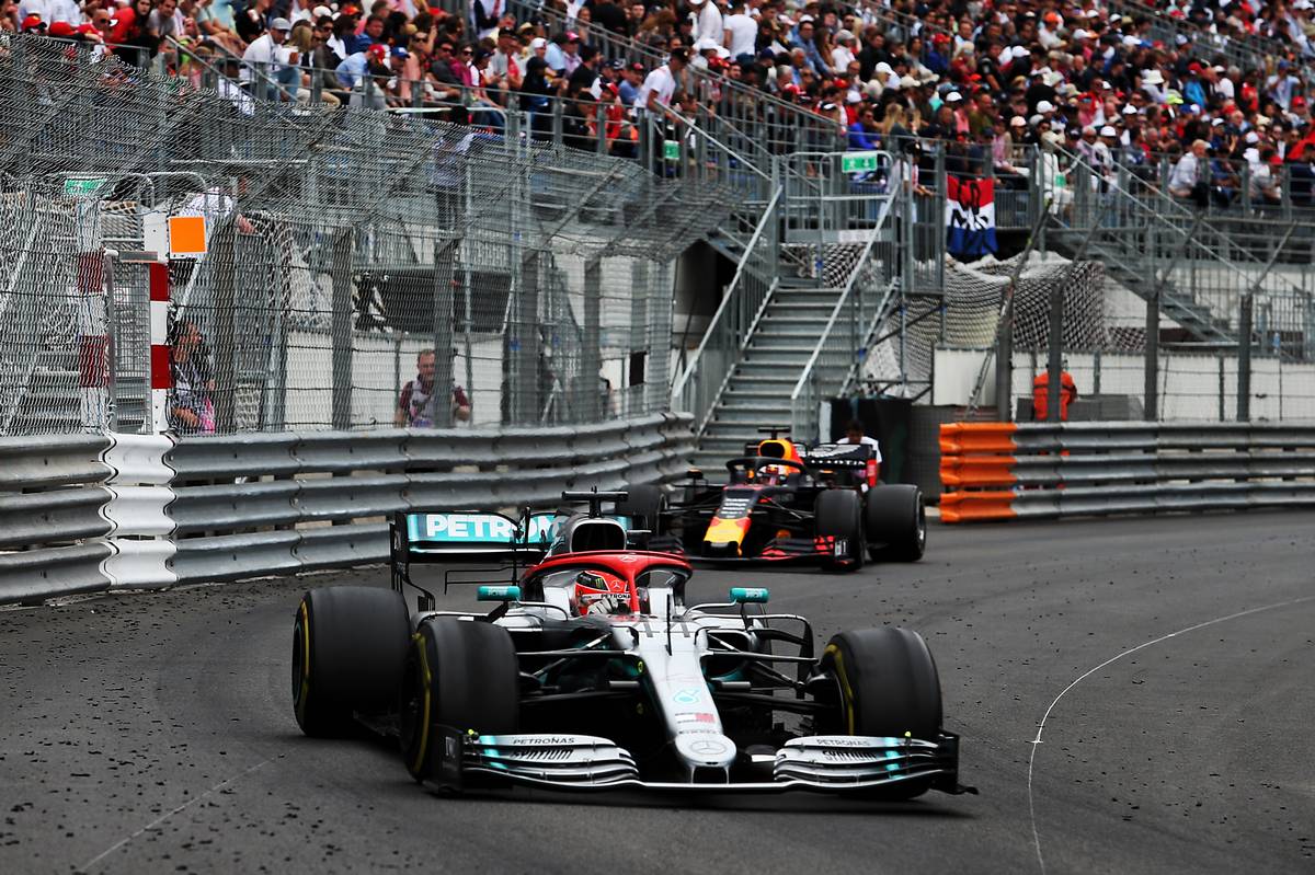 Lewis Hamilton (GBR) Mercedes AMG F1 W10 with Max Verstappen (NLD) Red Bull Racing RB15.