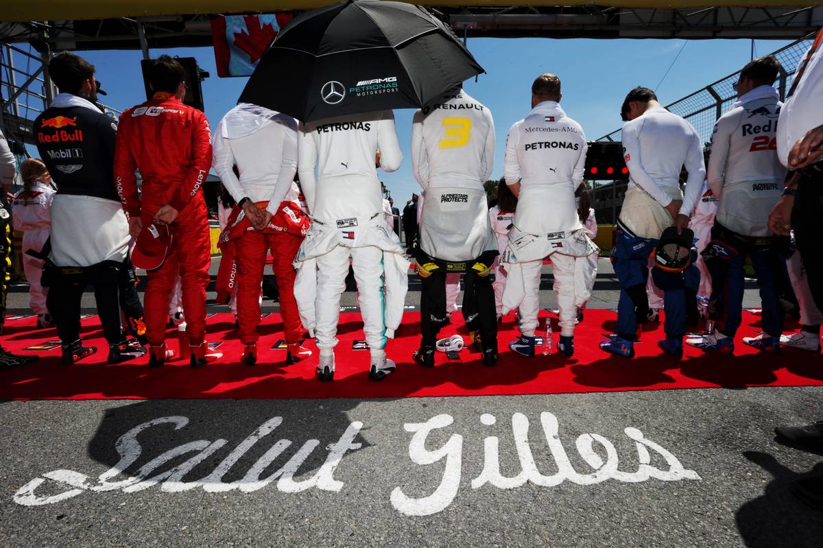 Drivers as the grid observes the national anthem.