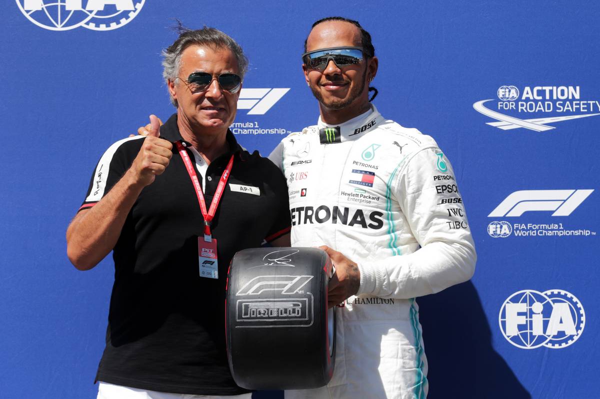 Lewis Hamilton (GBR) Mercedes AMG F1 (Right) receives the Pirelli pole position award from Jean Alesi (FRA).