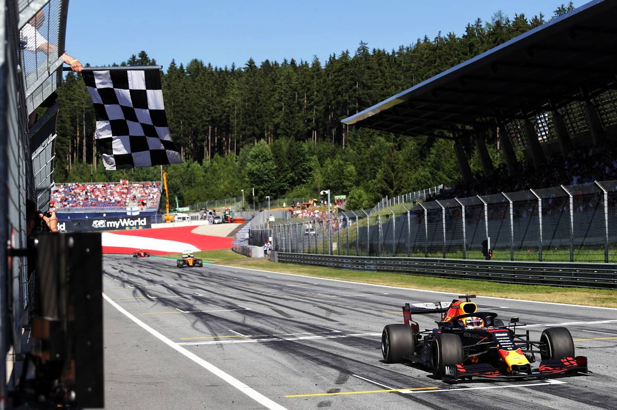 Race winner Max Verstappen (NLD) Red Bull Racing RB15 takes the chequered flag at the end of the race.