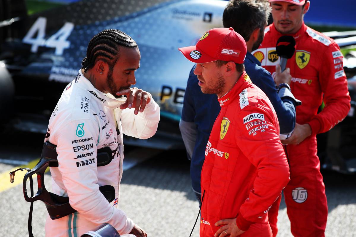 Lewis Hamilton (GBR) Mercedes AMG F1 in qualifying parc ferme with Sebastian Vettel (GER) Ferrari.