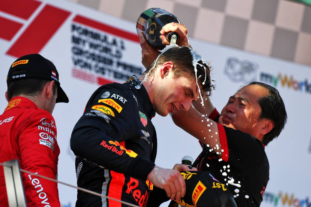 Race winner Max Verstappen (NLD) Red Bull Racing celebrates on the podium with Toyoharu Tanabe (JPN) Honda Racing F1 Technical Director.