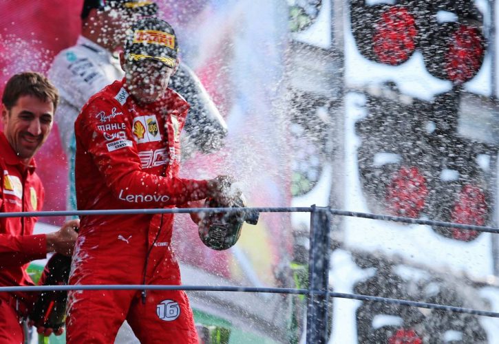 Race winner Charles Leclerc celebrate on the podium with the