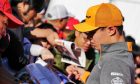Lando Norris (GBR) McLaren signs autographs for the fans.