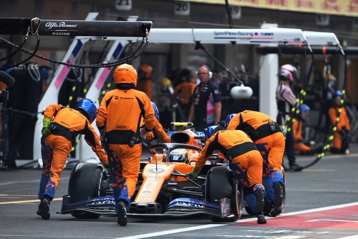 Lando Norris (GBR) McLaren MCL34 is pushed down by mechanics during the race.