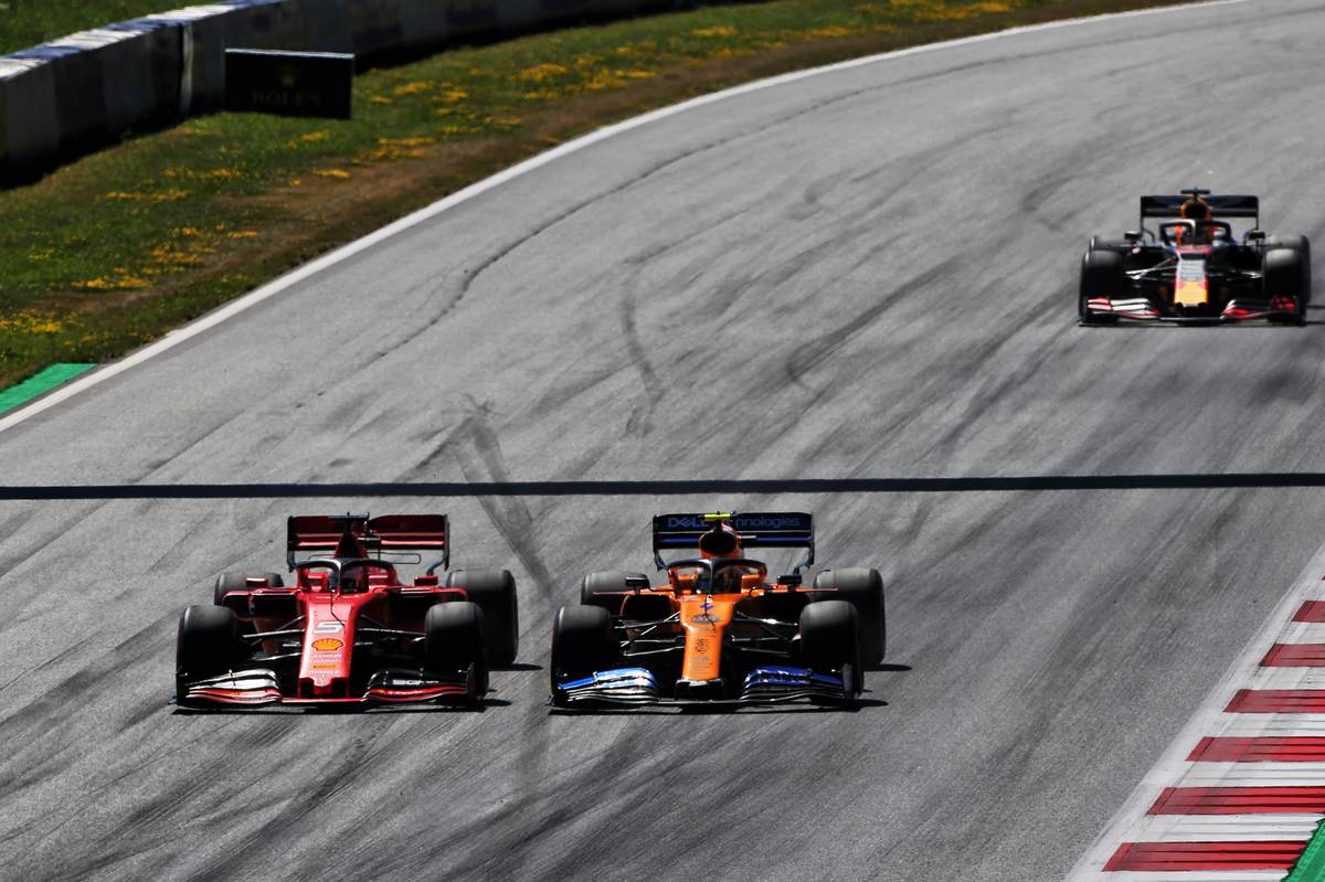 Sebastian Vettel (GER) Ferrari SF90 and Lando Norris (GBR) McLaren MCL34 battle for position.