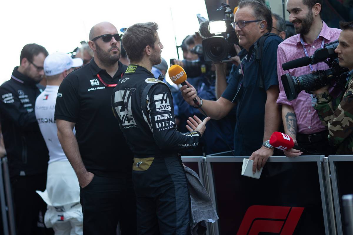 Romain Grosjean (FRA) Haas F1 Team with the media.