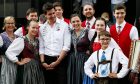 Toto Wolff (GER) Mercedes AMG F1 Shareholder and Executive Director with traditionally attired entertainers in the paddock.