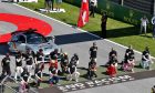 Some of the drivers take a knee on the grid, all wearing 'End Racism' T-shirts and Lewis Hamilton (GBR) Mercedes AMG F1 a 'Black Lives Matter' T-Shirt.