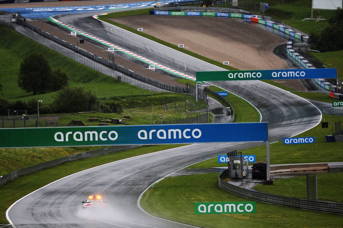 The FIA Safety Car laps the circuit as rain falls during qualifying.