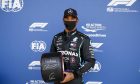 Lewis Hamilton (GBR) Mercedes AMG F1 celebrates his pole position in qualifying parc ferme with the Pirelli trophy.