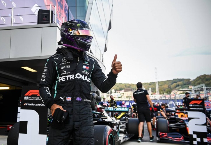Lewis Hamilton (GBR) Mercedes AMG F1 W11 celebrates his pole position in qualifying parc ferme.