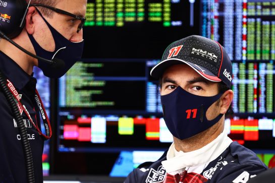 MEXICO CITY, MEXICO - NOVEMBER 05: Sergio Perez of Mexico and Red Bull Racing talks with his race engineer Hugh Bird in the garage during practice ahead of the F1 Grand Prix of Mexico at Autodromo Hermanos Rodriguez on November 05, 2021 in Mexico City, Mexico. (Photo by Mark Thompson/Getty Images) // Getty Images / Red Bull Content Pool  // SI202111050645 // Usage for editorial use only //