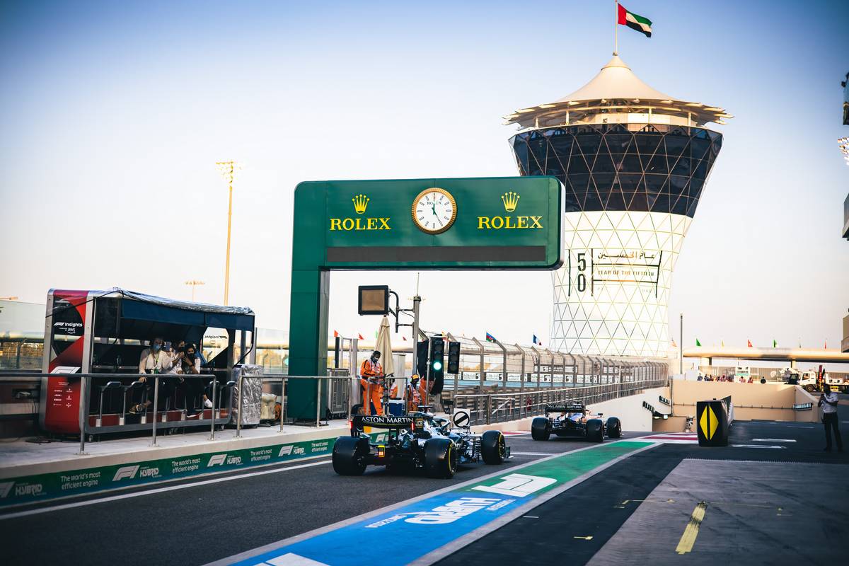 Lando Norris (GBR) McLaren MCL35M and Lance Stroll (CDN) Aston Martin F1 Team AMR21 leave the pits. 11.12.2021. Formula 1 World Championship, Rd 22, Abu Dhabi Grand Prix, Yas Marina