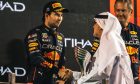 Sergio Perez (MEX) Red Bull Racing celebrates his third position on the podium. 20.11.2022. Formula 1 World Championship, Rd 22, Abu Dhabi Grand Prix, Yas Marina Circuit, Abu Dhabi, Race