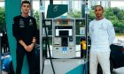 George Russell and Lewis Hamilton man the pumps at a gas station for a promotional shoot for long-time Mercedes sponsor Petronas.