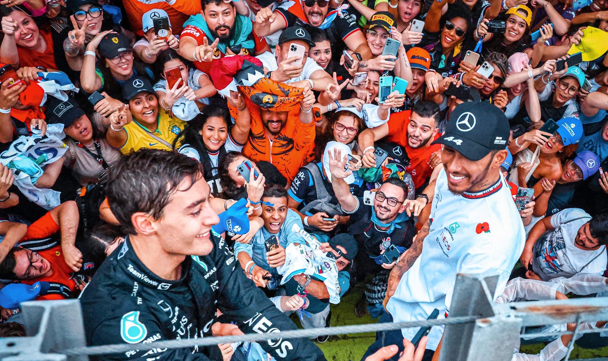 George Russell and Lewis Hamilton celebrate with fans in Brazil after finishing 1-2 at Sao Paulo