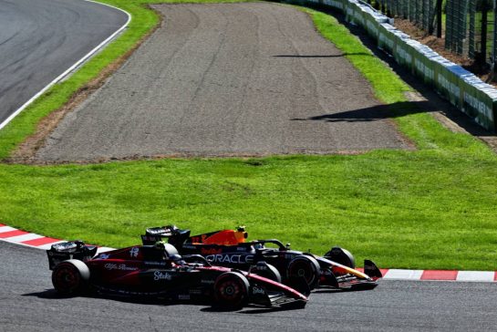Sergio Perez (MEX) Red Bull Racing RB19 and Zhou Guanyu (CHN) Alfa Romeo F1 Team C43 battle for position.
24.09.2023. Formula 1 World Championship, Rd 17, Japanese Grand Prix, Suzuka, Japan, Race Day.
- www.xpbimages.com, EMail: requests@xpbimages.com © Copyright: Coates / XPB Images