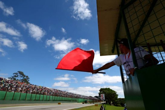 Circuit atmosphere - marshal waves the red flag.
05.11.2023. Formula 1 World Championship, Rd 21, Brazilian Grand Prix, Sao Paulo, Brazil, Race Day.
 - www.xpbimages.com, EMail: requests@xpbimages.com © Copyright: Coates / XPB Images