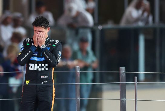 ABU DHABI, UNITED ARAB EMIRATES - DECEMBER 07: 2025 F1 World Drivers Champion and Third placed Lando Norris of Great Britain and McLaren celebrates on the podium during the F1 Grand Prix of Abu Dhabi at Yas Marina Circuit on December 07, 2025 in Abu Dhabi, United Arab Emirates. (Photo by Dom Gibbons/Getty Images)
