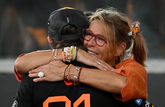 ABU DHABI, UNITED ARAB EMIRATES - DECEMBER 07: Cisca Norris congratulates Second placed Oscar Piastri of Australia and McLaren in parc ferme during the F1 Grand Prix of Abu Dhabi at Yas Marina Circuit on December 07, 2025 in Abu Dhabi, United Arab Emirates. (Photo by Michael Potts/LAT Images)