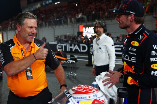 ABU DHABI, UNITED ARAB EMIRATES - DECEMBER 07: Zak Brown, Chief Executive Officer of McLaren congratulates Race winner Max Verstappen of the Netherlands and Oracle Red Bull Racing in parc ferme during the F1 Grand Prix of Abu Dhabi at Yas Marina Circuit on December 07, 2025 in Abu Dhabi, United Arab Emirates. (Photo by Mark Thompson/Getty Images)