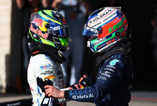 AUSTIN, TEXAS - OCTOBER 24: Second placed qualifier Max Verstappen of the Netherlands and Oracle Red Bull Racing and Third placed qualifier Isack Hadjar of France and Oracle Red Bull Racing talk in parc ferme during qualifying ahead of the F1 Grand Prix of United States at Circuit of The Americas on October 24, 2026 in Austin, Texas. (Photo by Sam Bloxham/LAT Images) // Getty Images / Red Bull Content Pool // SI202610250007 // Usage for editorial use only //
